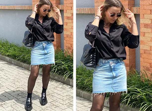 Look de camisa preta com saia jeans curta com meia-calça preta